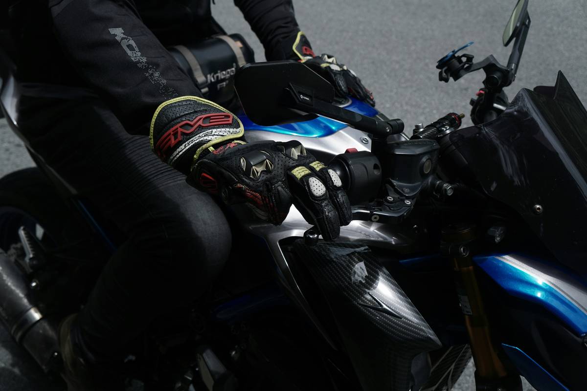 Close-up of Certified Safety Gloves showing EN 388 rating tag and reinforced knuckle padding